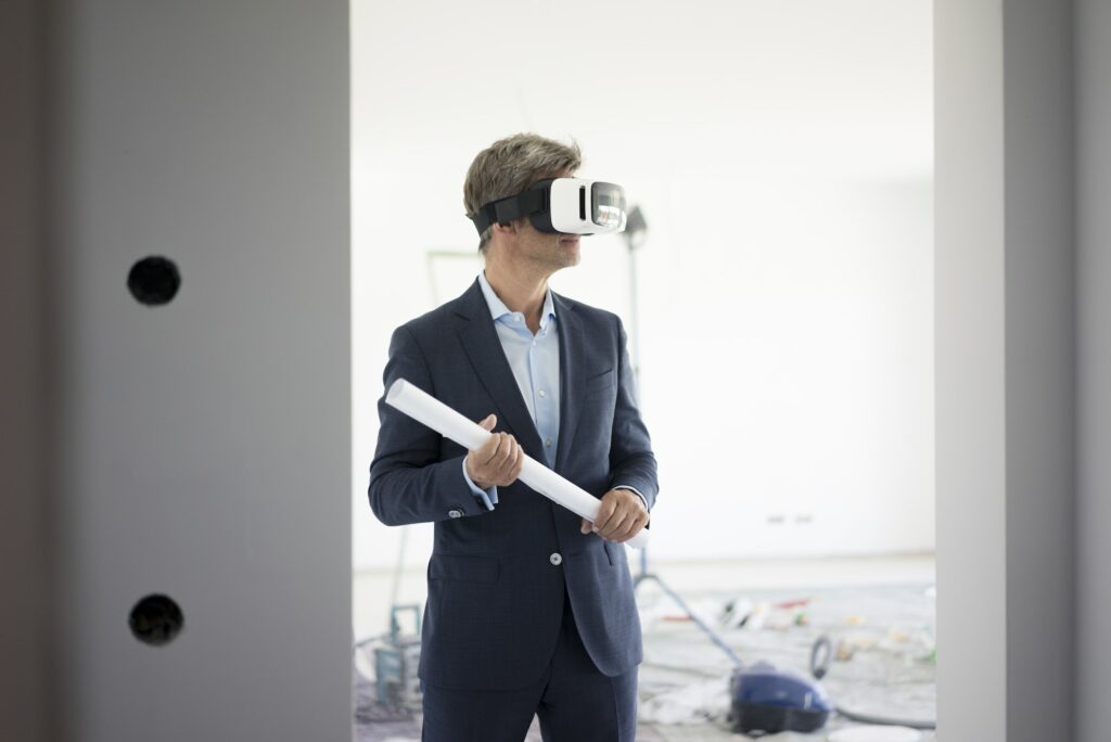 Man in suit wearing VR glasses in building under construction