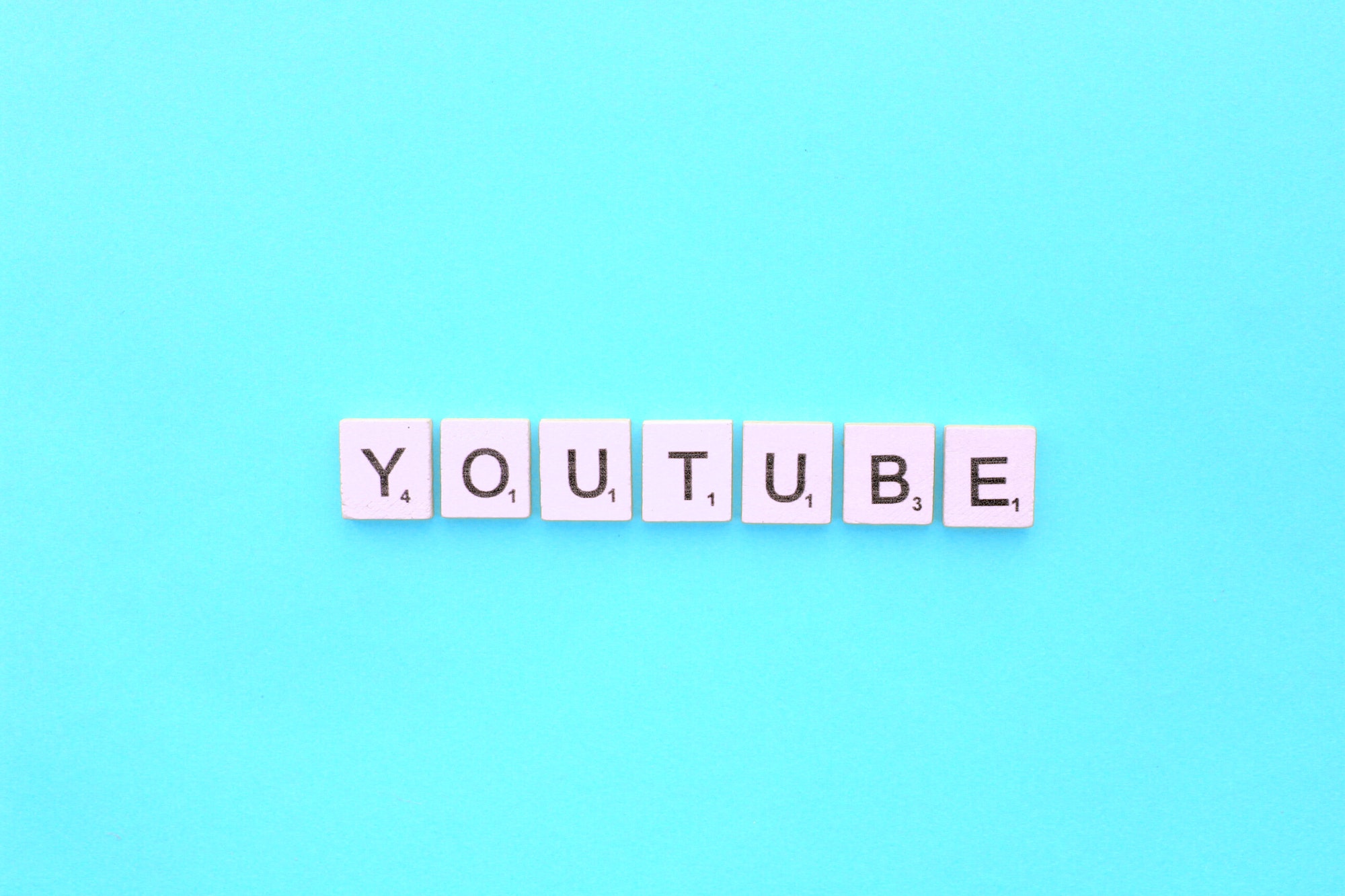 YouTube scrabble letters word on a light blue background